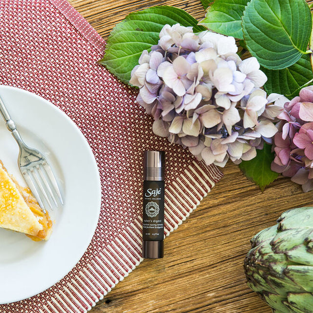 Eater's Digest on a table with muted flowers and a plate showing a piece of pie with a fork beside it