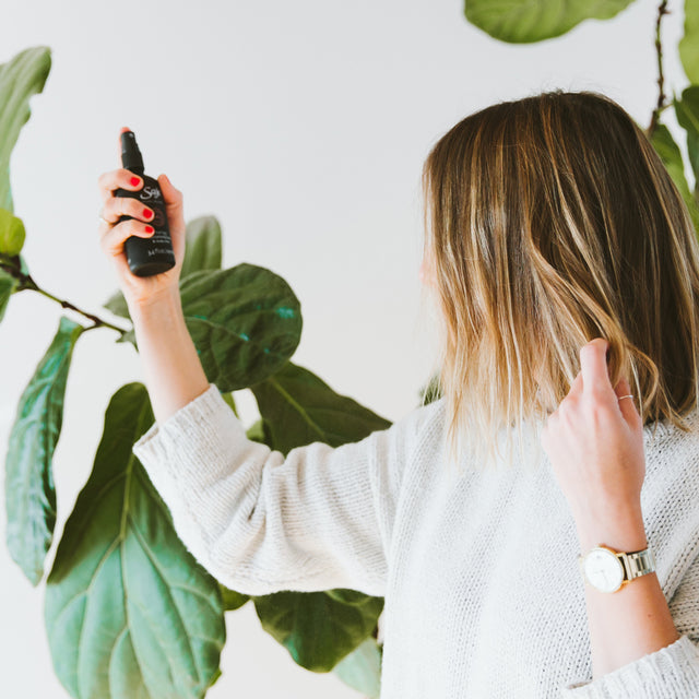 A person spraying unwind mist