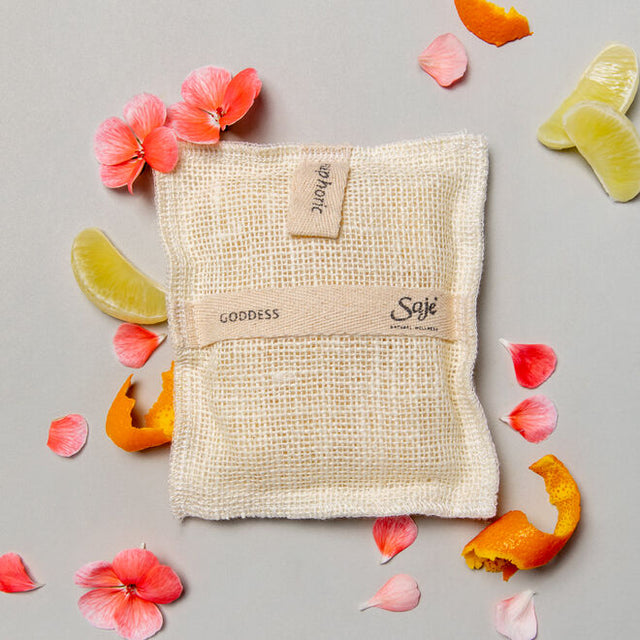 Goddess jute and joy body wash pad surrounded by flowers and citrus