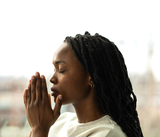 A woman takes a Saje breath with her eyes closed.