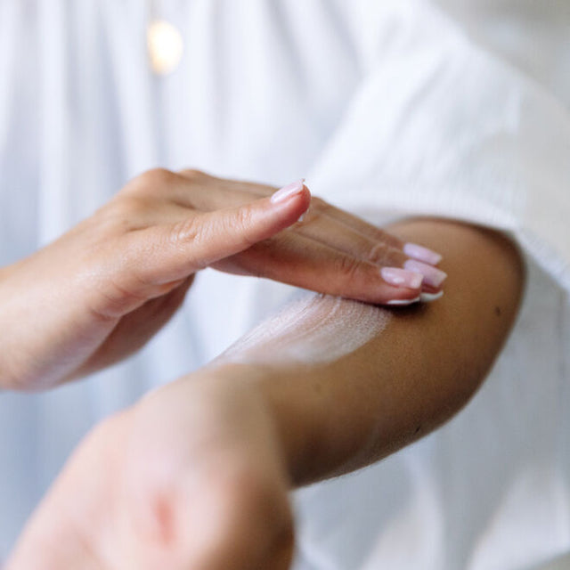 person applying Safe Hands Hand Cream on arm