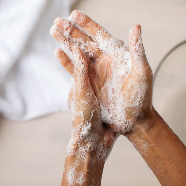 A person washing their hands with Safe Hands hand soap 